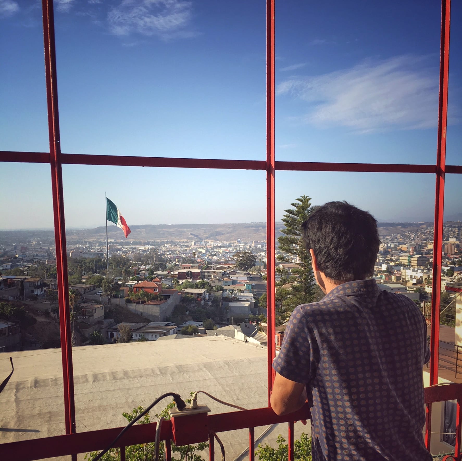 Shinpei Takeda looking out over Tijuana from his balcony. Photo by Chi Essary