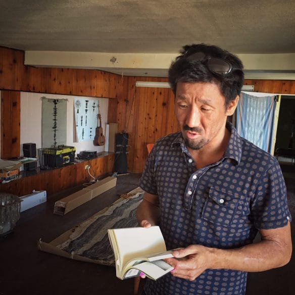 Takeda talks about the two Japanese published books about his work. Photo by Chi Essary